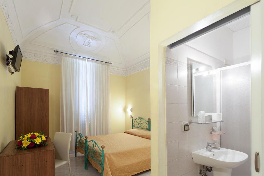 Postel nebo postele na pokoji v ubytování Hotel Oriente