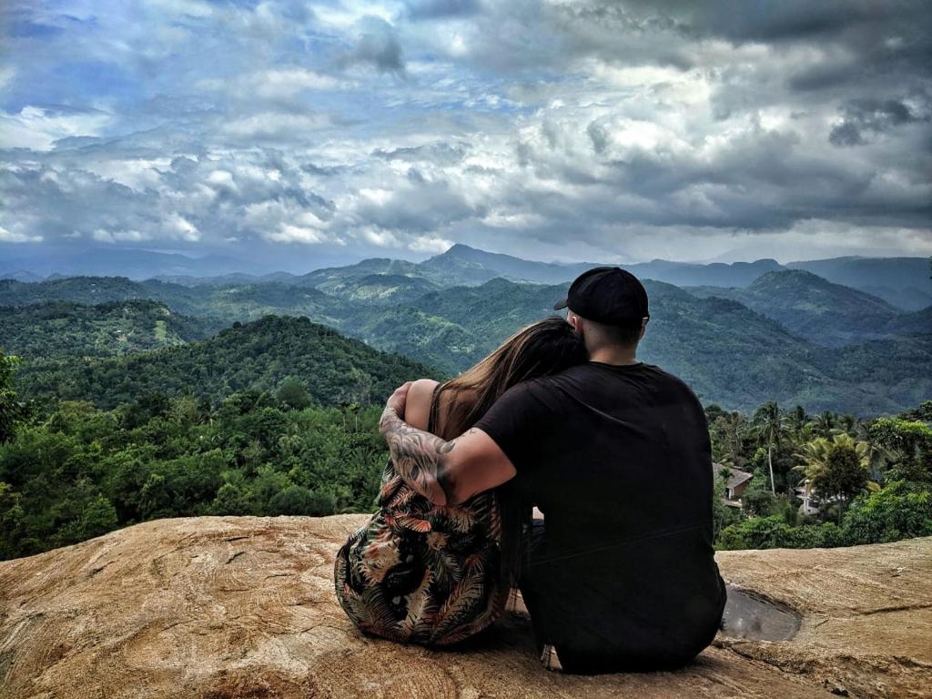 a man and a woman sitting on top of a mountain at The Cloud Resort in Kadugannawa