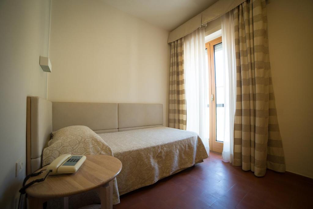Postel nebo postele na pokoji v ubytování Hotel Miramare