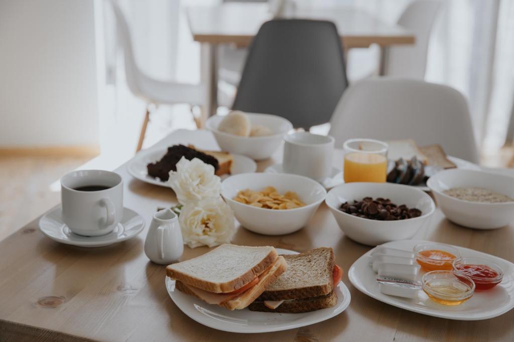 a table topped with plates of breakfast foods and coffee at Vivari Acta in Vivari