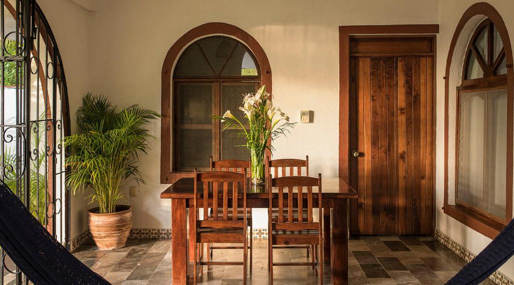 a dining room with a wooden table and chairs at Villas Carrizalillo in Puerto Escondido
