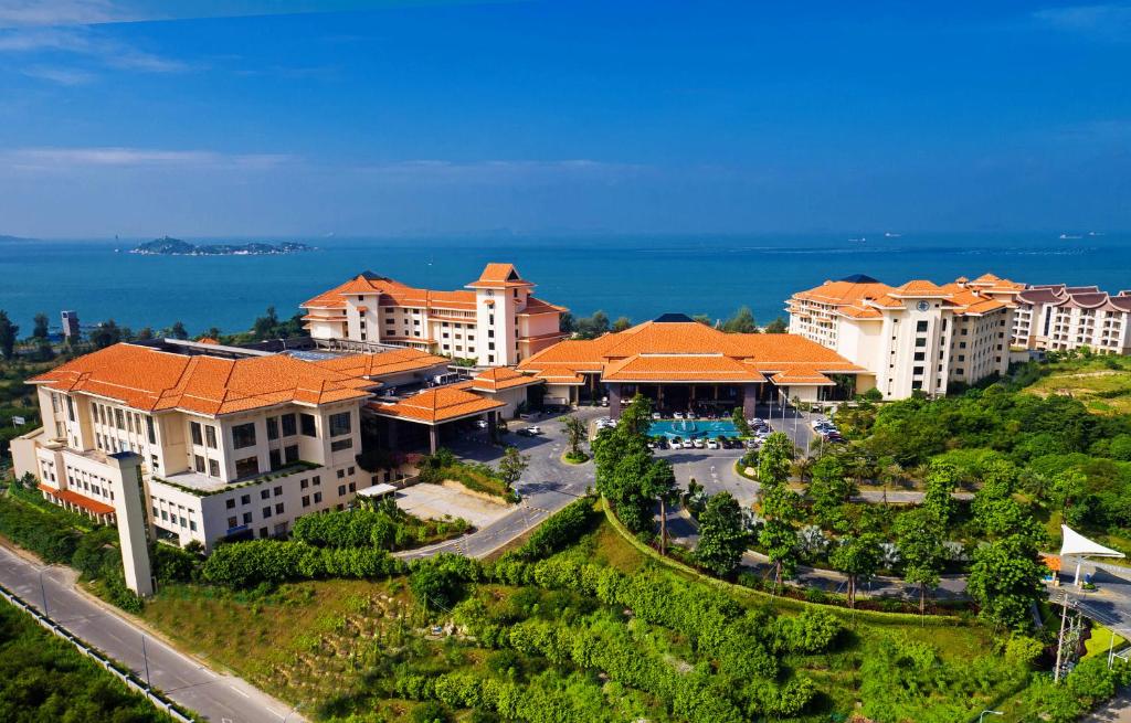 an aerial view of a resort with the ocean in the background at Huidong Regal Palace Resort in Huidong