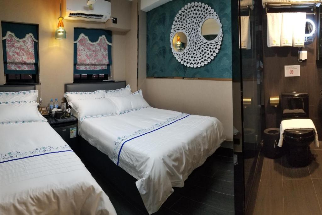 Postel nebo postele na pokoji v ubytování Star City Hotel