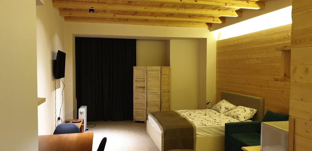 Un pat sau paturi într-o cameră la New Gudauri Suites