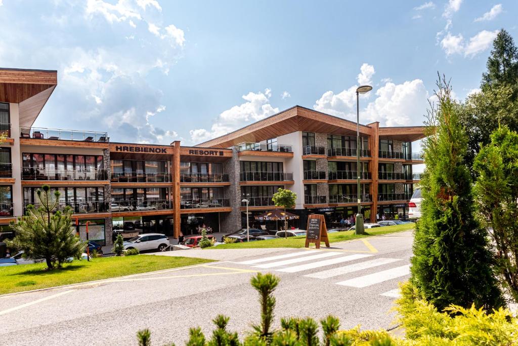 a building with a parking lot in front of it at Studio Hrebienok 212 in Starý Smokovec