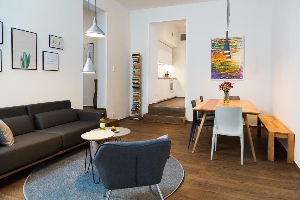 a living room with a couch and a table at BENSIMON apartments Charlottenburg in Berlin