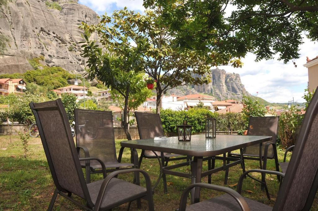 a table and chairs with a mountain in the background at Garden House / Amazing View in Kalabaka