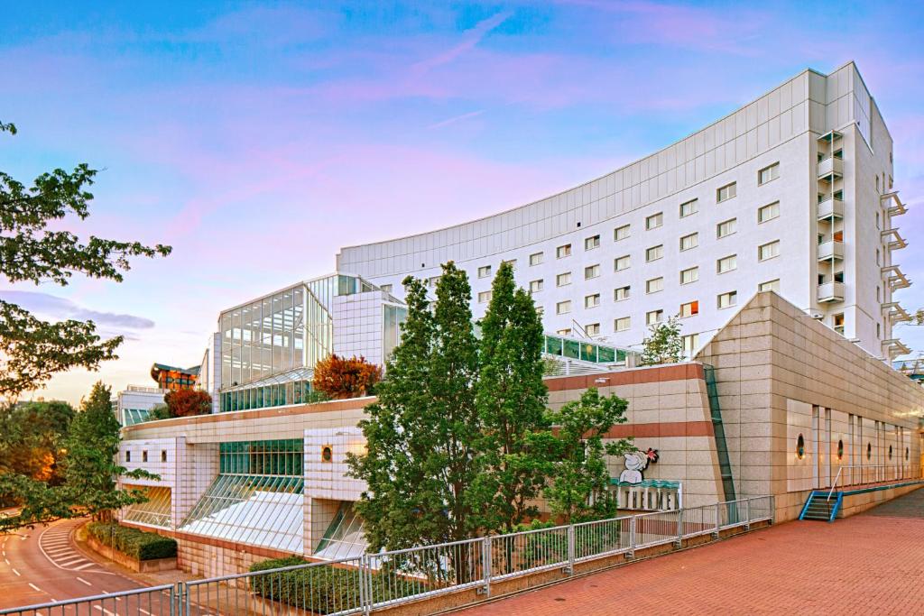 un gran edificio blanco con árboles delante de él en Trip Inn Frankfurt Nordwestzentrum, en Frankfurt