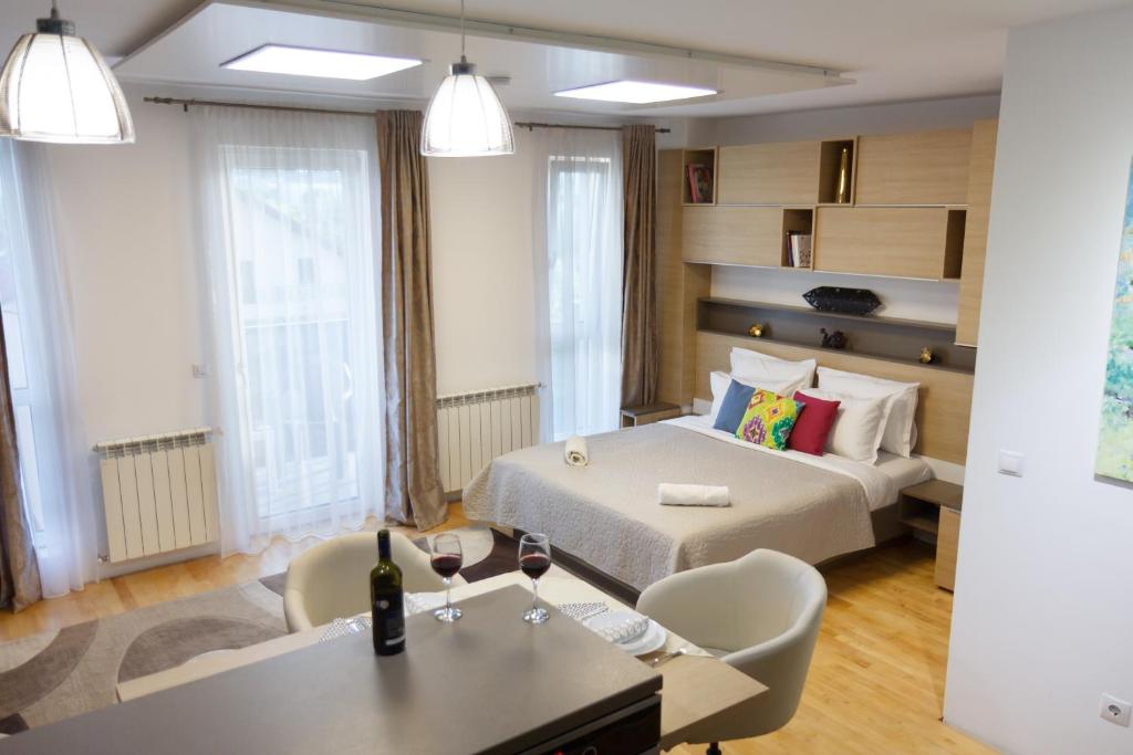 a hotel room with a bed and a table and chairs at Presecan One Room Apartment with view in Cluj-Napoca