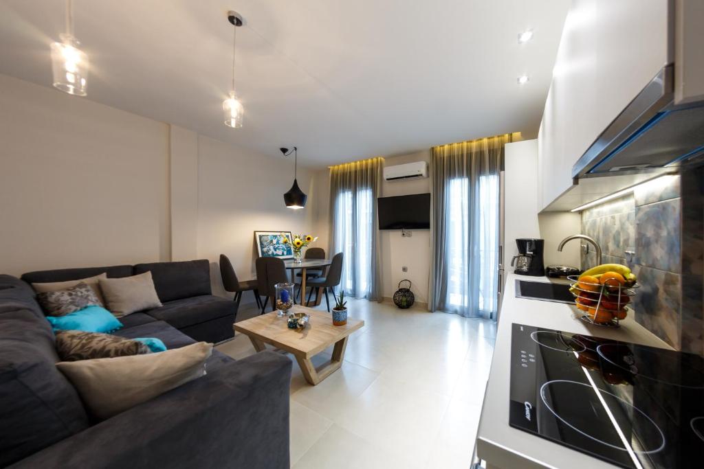 a living room with a couch and a table at San Marco Elegant Apartment Zante in Zakynthos