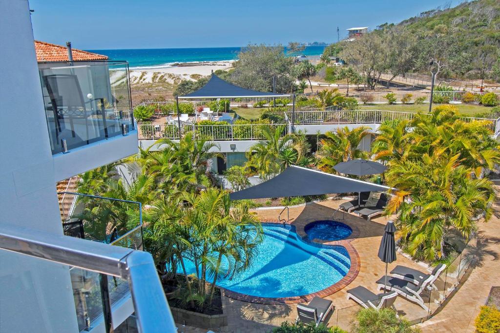 an aerial view of a resort with a swimming pool and the beach at Sandcastles On Currumbin Beach in Gold Coast