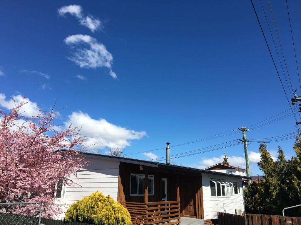 a house with a fence and a blue sky at 46 MacKenzie in Twizel