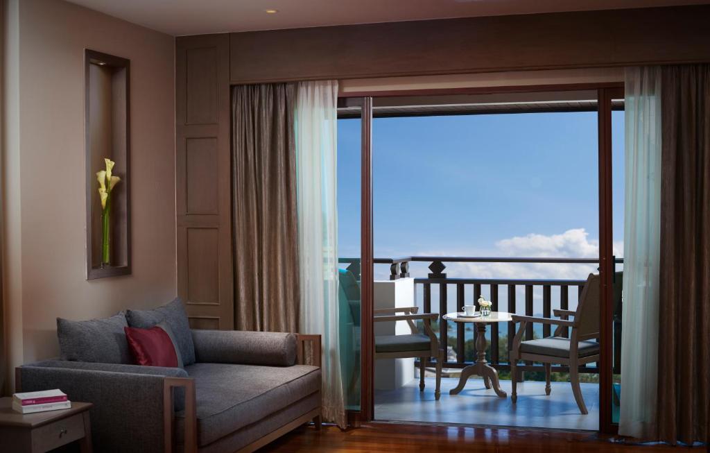 a living room with a couch and a table at Amari Vogue Krabi in Tab Kaek Beach