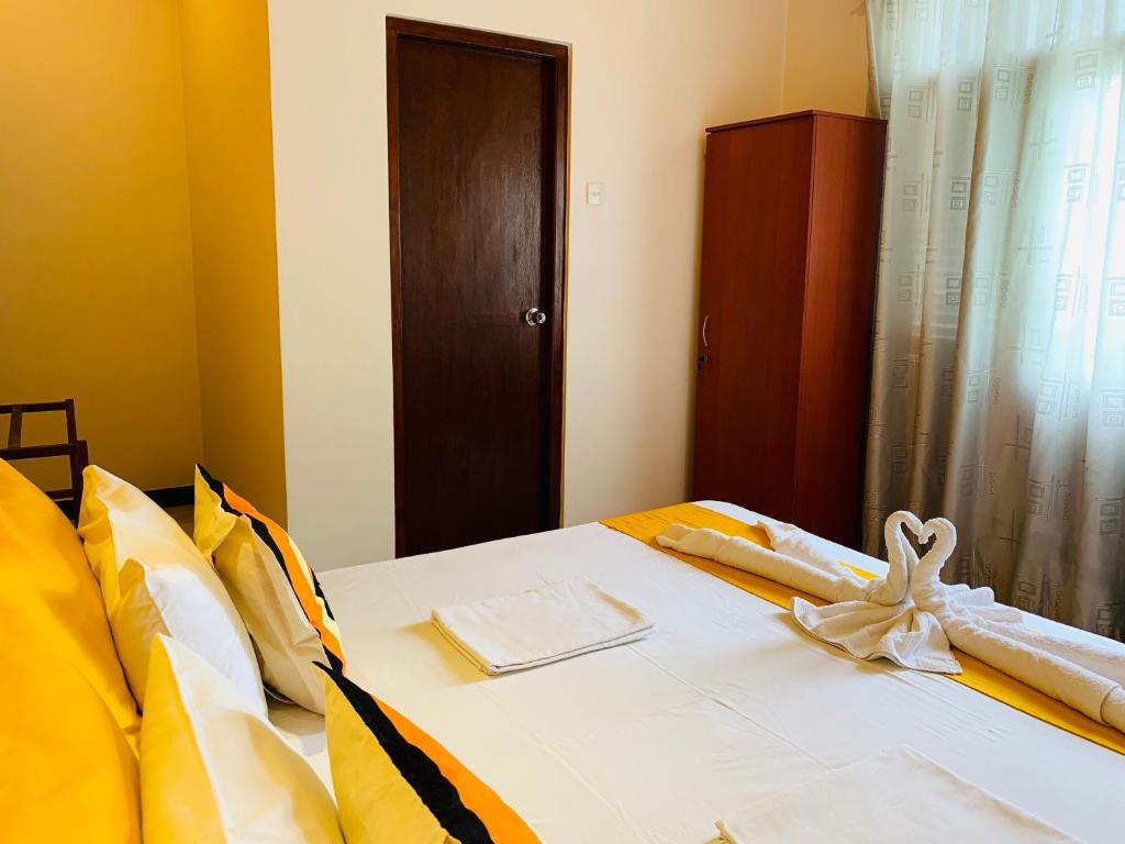 Postel nebo postele na pokoji v ubytování Sam's Guest House
