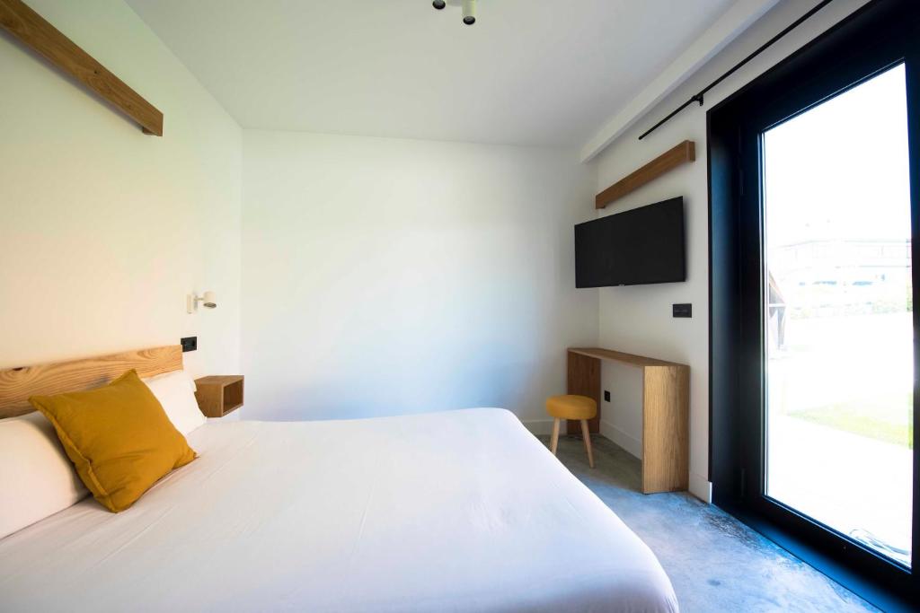 Postel nebo postele na pokoji v ubytování Moana Eco Surf House