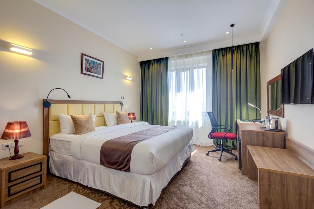Postel nebo postele na pokoji v ubytování Garden Hotel & SPA