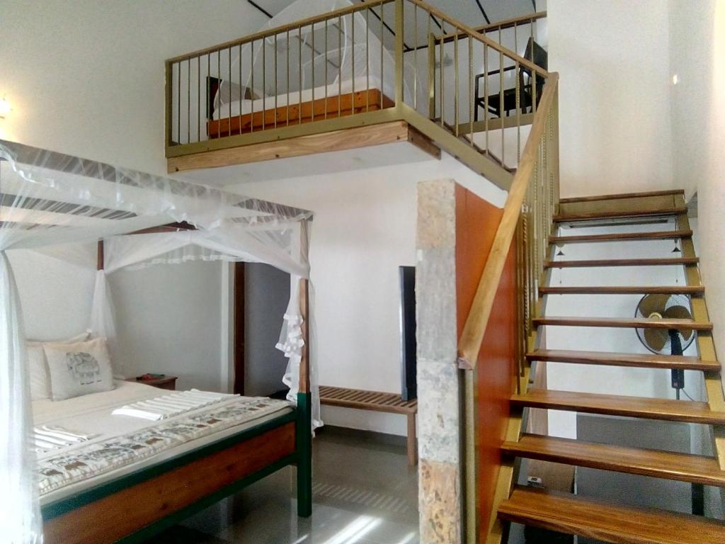 Postel nebo postele na pokoji v ubytování Suriya Arana
