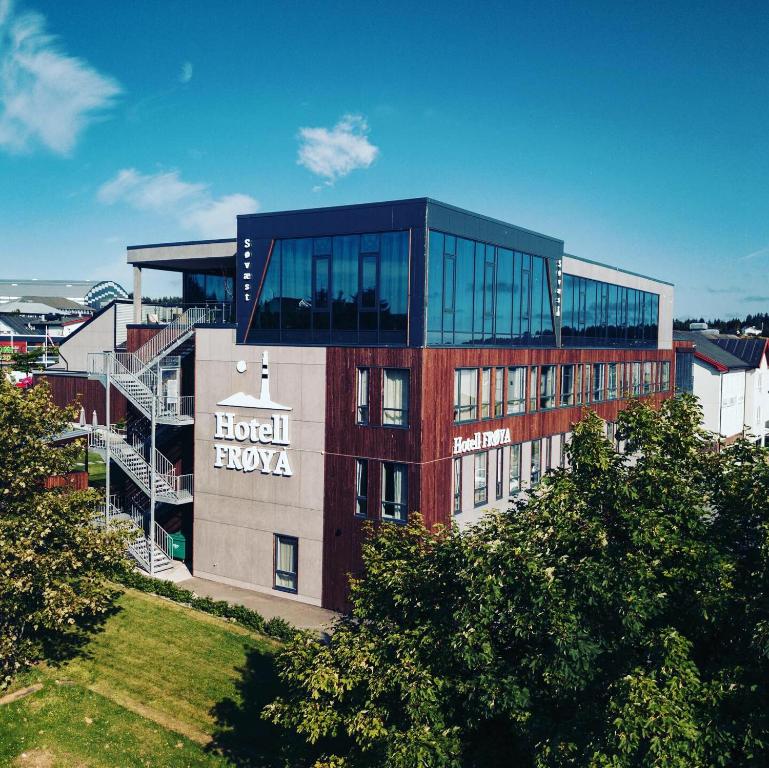 a building with a sign on the side of it at Hotel Frøya in Sistranda