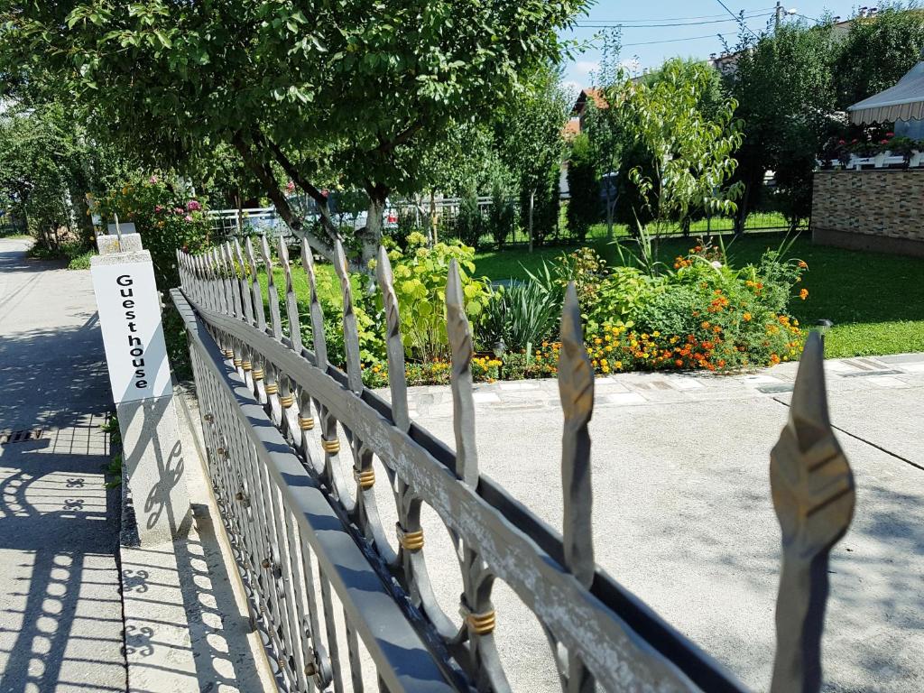 a wooden fence with a garden in the background at Guesthouse Relax and Fly Sarajevo in Sarajevo