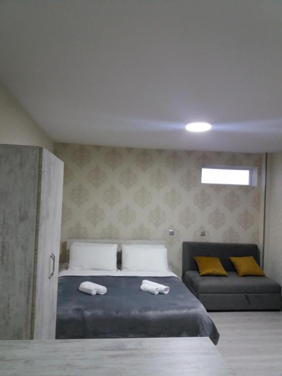 a bedroom with a bed with two towels on it at Apartament LashaGiorgi in Borjomi