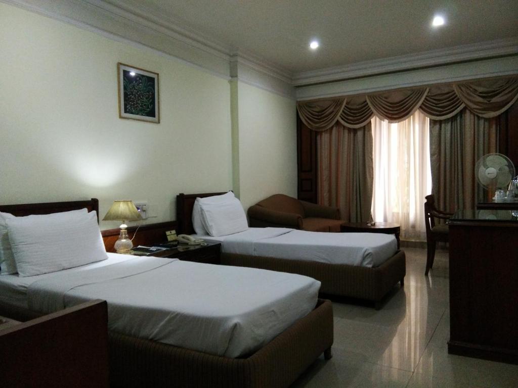 Postel nebo postele na pokoji v ubytování Hotel Empires