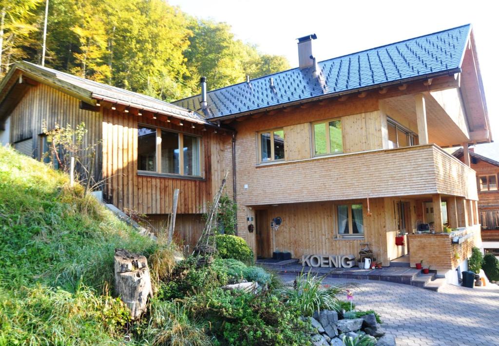 ein großes Holzhaus mit einem Gamer-Dach in der Unterkunft Haus König in Bezau