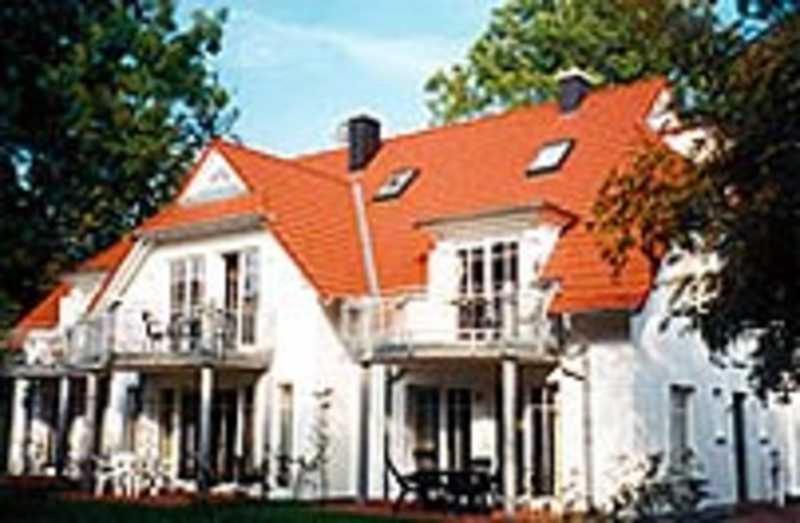 une grande maison blanche avec un toit orange dans l'établissement Alte Reihe 9 Wohnung 5, à Zingst