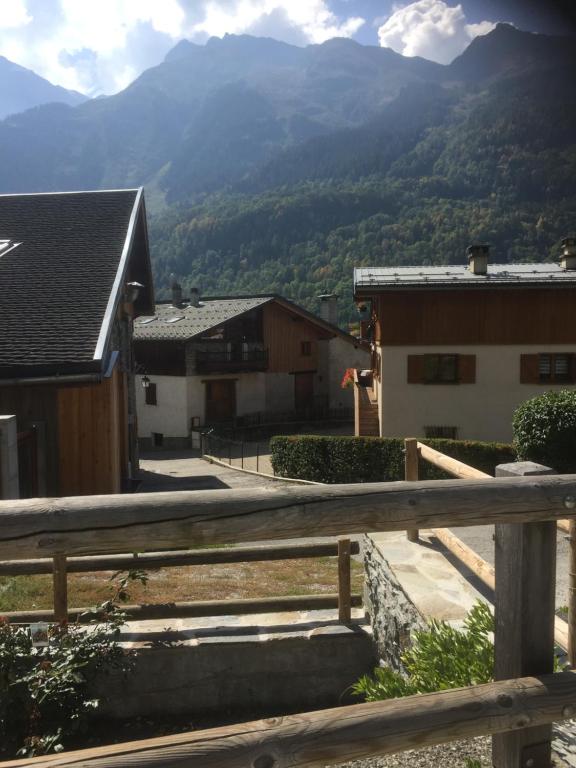 a view of the mountains from a wooden fence at Le petit Saint Bernard in Sainte-Foy-Tarentaise