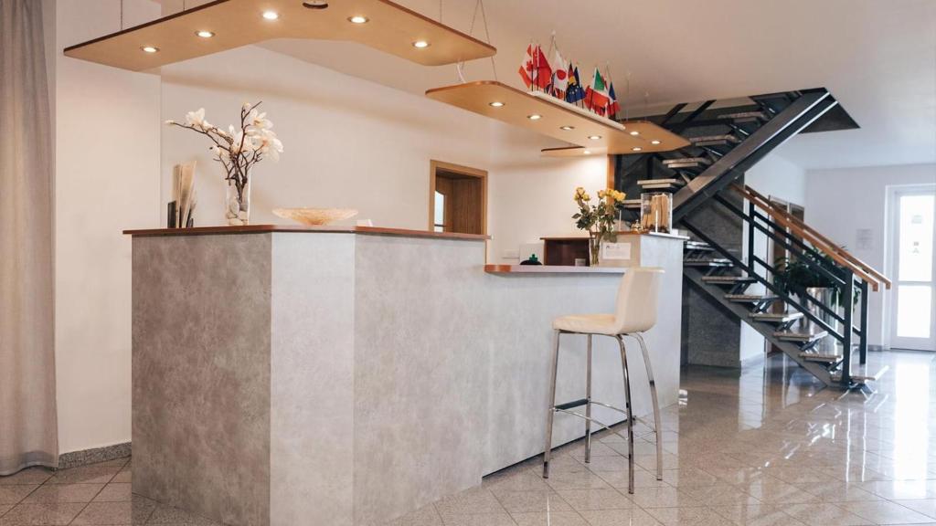 a kitchen with a counter and a staircase at Penzion Solid Spa in Mladá Boleslav