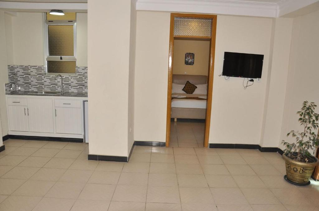a large room with a kitchen and a television at Mekelle Hotel in Mekʼelē
