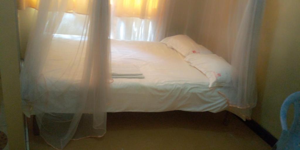 Postel nebo postele na pokoji v ubytování Hotel Jaffers Nairobi