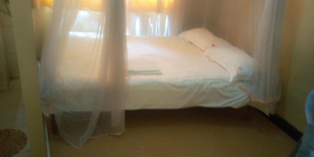Postel nebo postele na pokoji v ubytování Hotel Jaffers Nairobi
