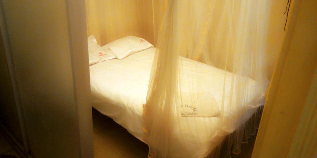 Postel nebo postele na pokoji v ubytování Hotel Jaffers Nairobi