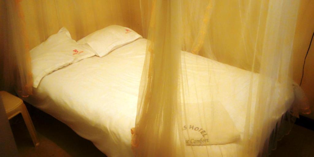 Postel nebo postele na pokoji v ubytování Hotel Jaffers Nairobi