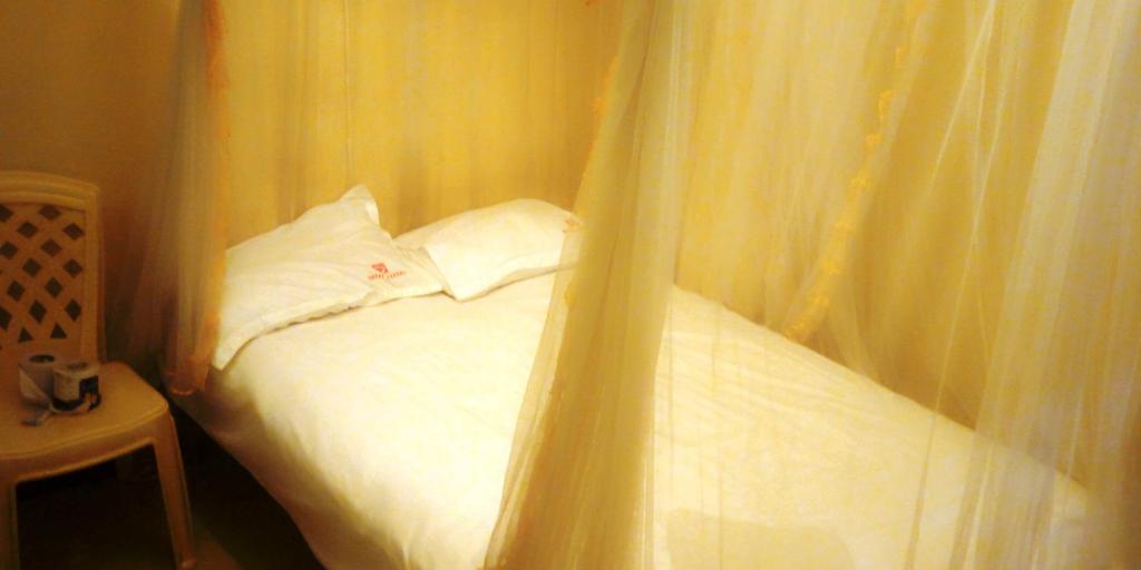 Postel nebo postele na pokoji v ubytování Hotel Jaffers Nairobi