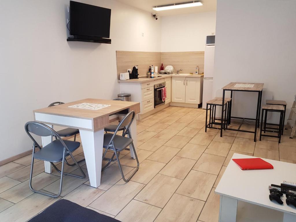 a kitchen with a table and chairs in a room at Lourdes Guest House in Lourdes