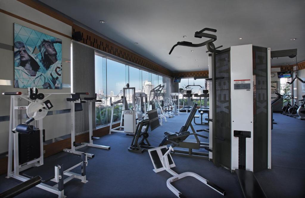 a gym with cardio equipment in a building at Amari Bangkok in Bangkok