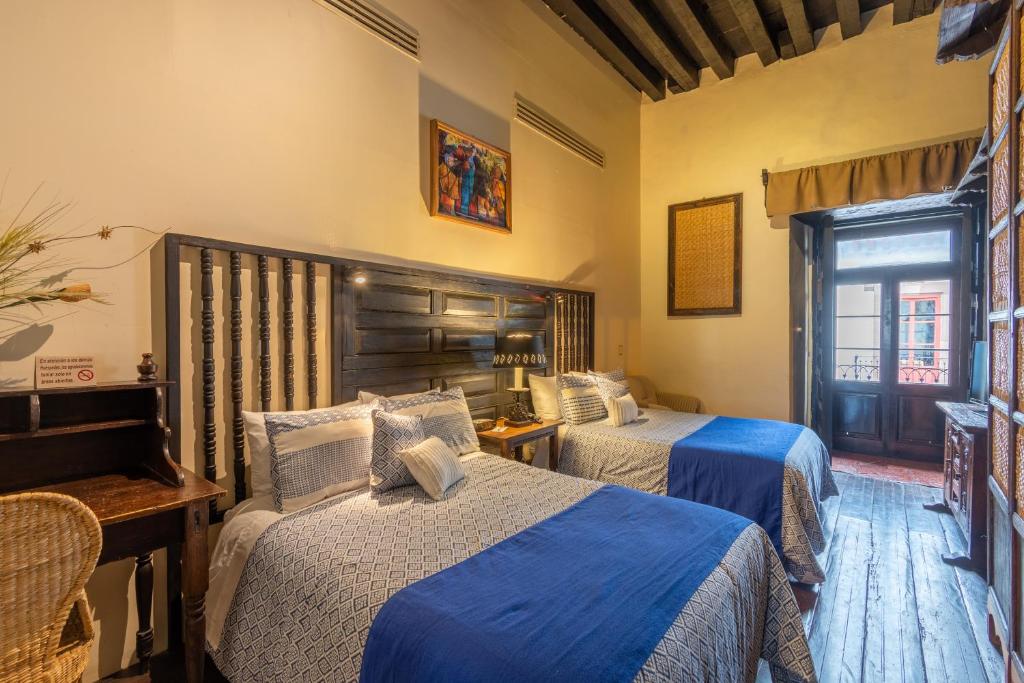 Postel nebo postele na pokoji v ubytování Hotel Mansion Iturbe
