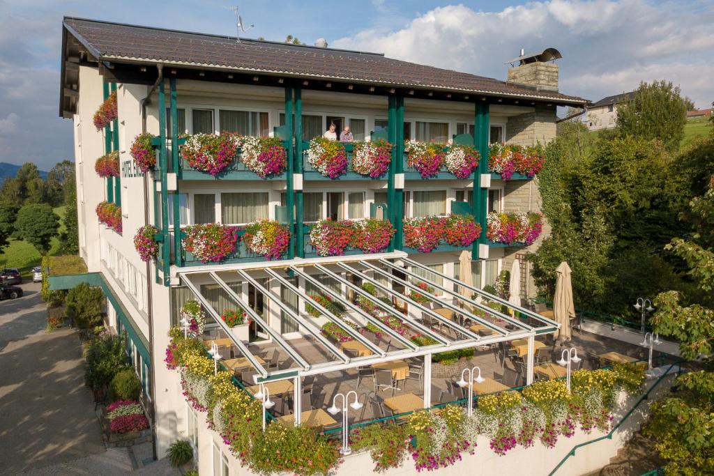 a hotel with flowerpots on the side of a building at Hotel Engel Alberschwende in Alberschwende