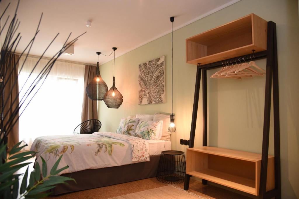 a bedroom with a canopy bed and a window at CasaGreek Monastiraki - Athens in Athens