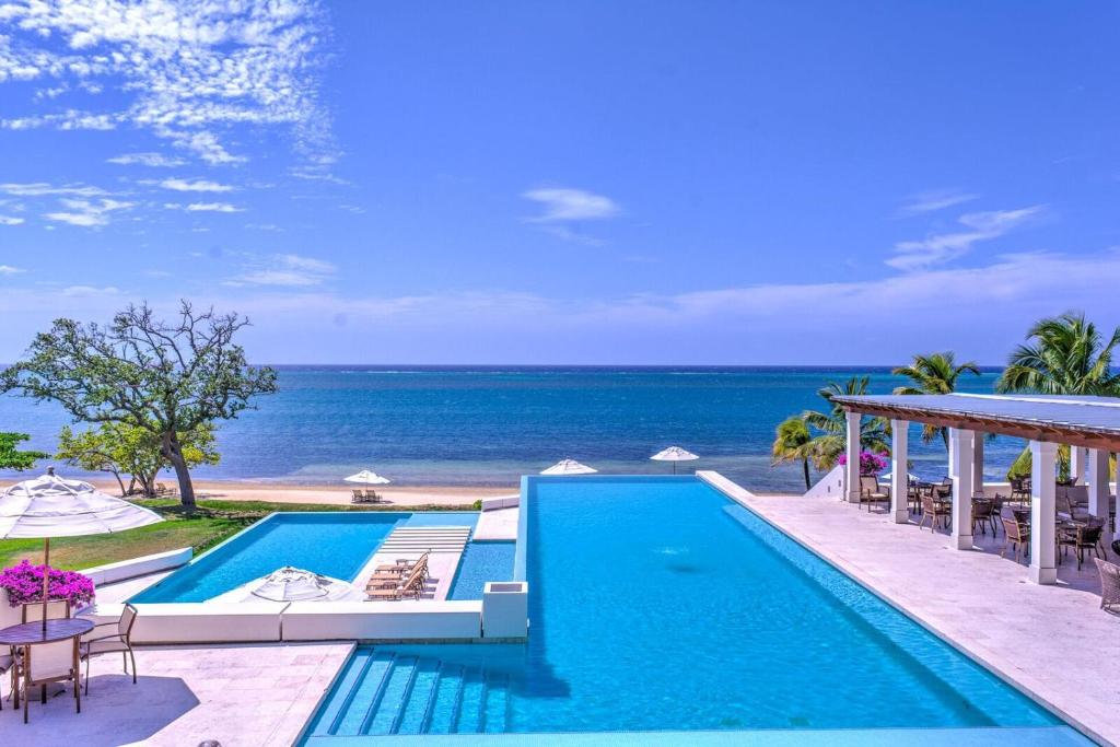a swimming pool with a view of the ocean at Las Verandas Hotel & Villas in First Bight