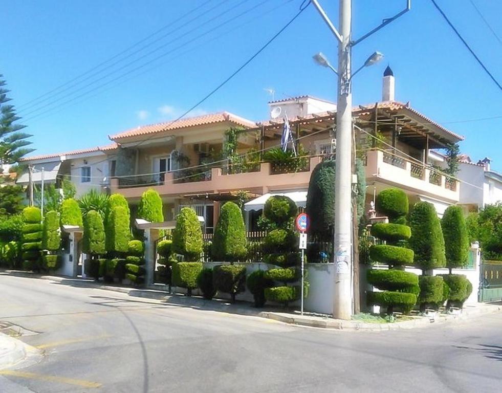 dom z mnóstwem krzaków przed nim w obiekcie Stella's Home w mieście Glyka Nera