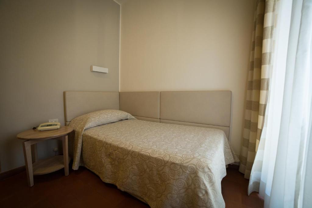Postel nebo postele na pokoji v ubytování Hotel Miramare