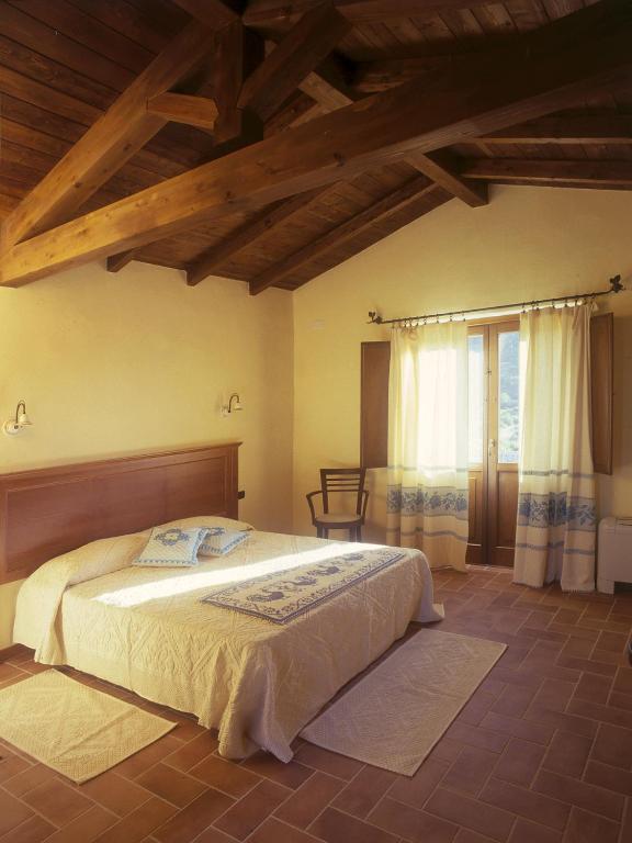Postel nebo postele na pokoji v ubytování Hotel Giardino Corte Rubja