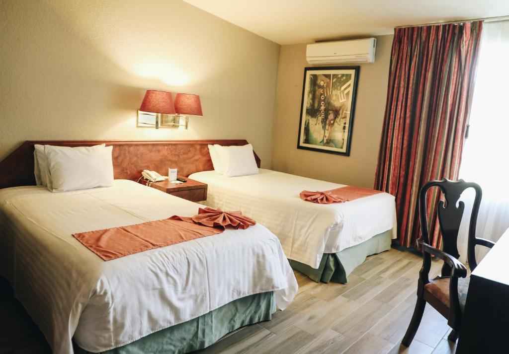 Postel nebo postele na pokoji v ubytování Hotel La Joya Tulancingo