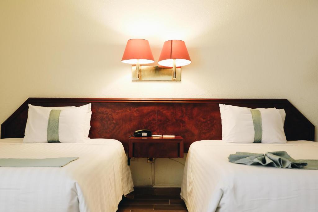Postel nebo postele na pokoji v ubytování Hotel La Joya Tulancingo