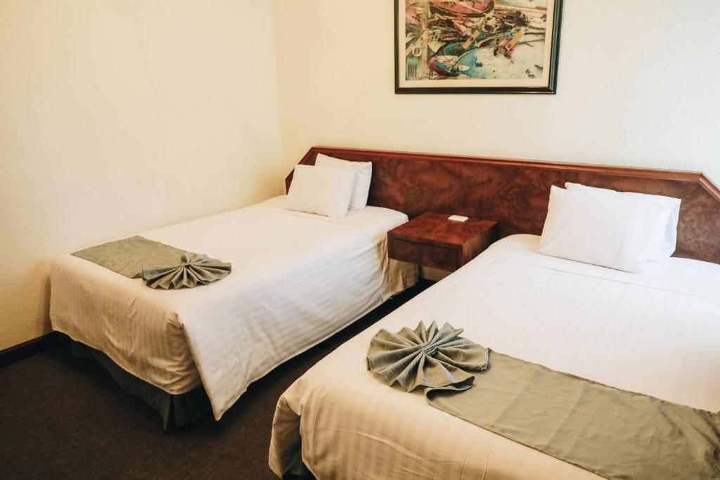 Postel nebo postele na pokoji v ubytování Hotel La Joya Tulancingo