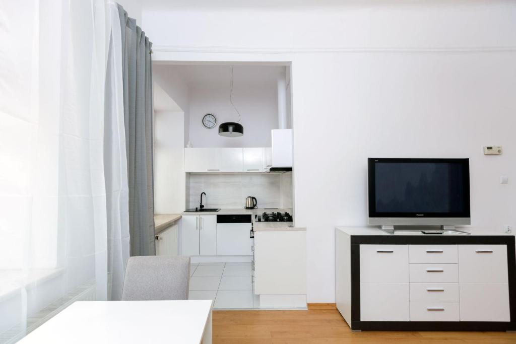 a white kitchen with a television on a counter at Apartment - OLD TOWN - Cyrulicza in Lublin