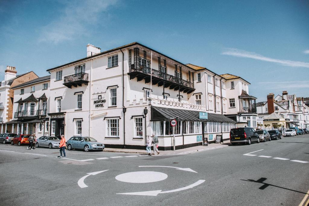 a large white building on the corner of a street at Bedford Hotel in Sidmouth