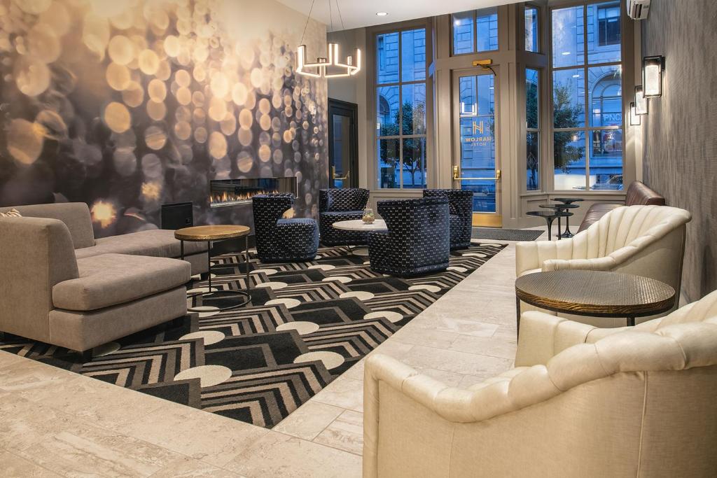 a lobby with couches and chairs and a fireplace at Harlow Hotel in Portland